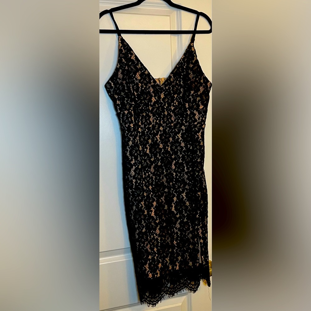 Sexy black dress! NEVER worn. Fully lined. Zipper in back. Slight slit in front